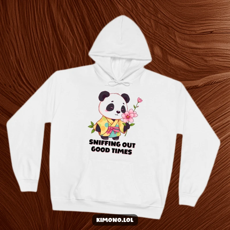 Funny playful panda in a colorful kimono curiously sniffing a blooming flower, cozy hoodie art.